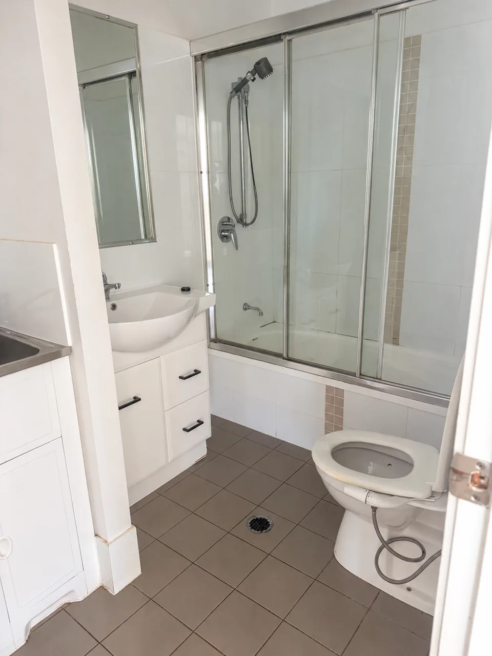 Bathroom with glass shower, vanity and toilet after cleaning